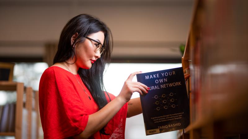 Girl getting a book at the library